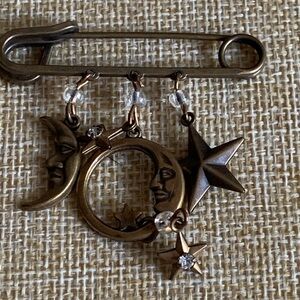 Vintage celestial theme brooch with a lot of interesting elements.